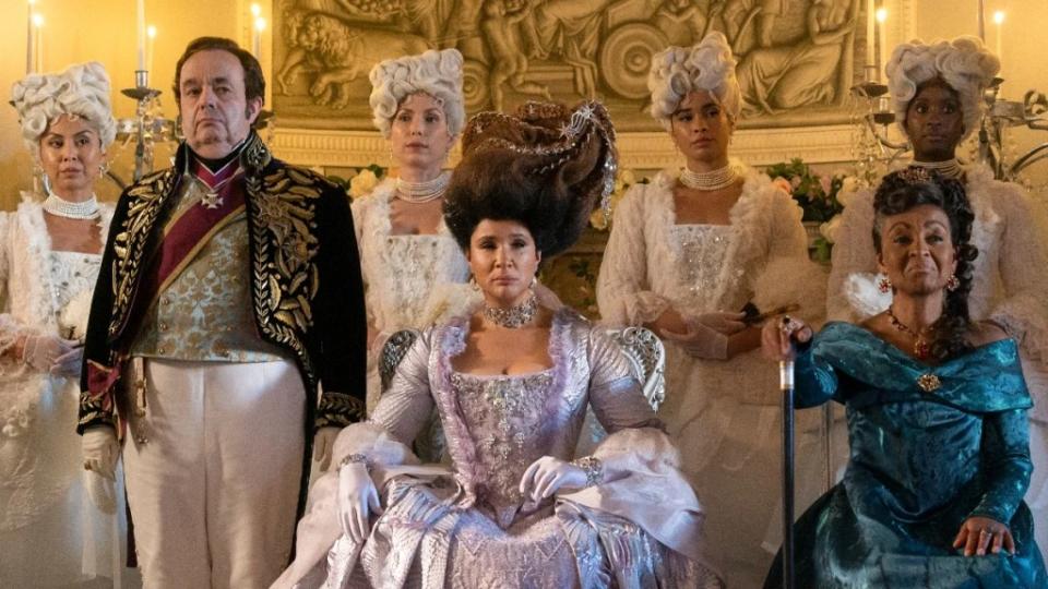 Queen Charlotte (Golda Rosheuvel) in between her trusty aid Brimsley (Hugh Sachs) and Lady Danbury (Adjoah Andoh) in Season 3 of “Bridgerton” (Netflix)