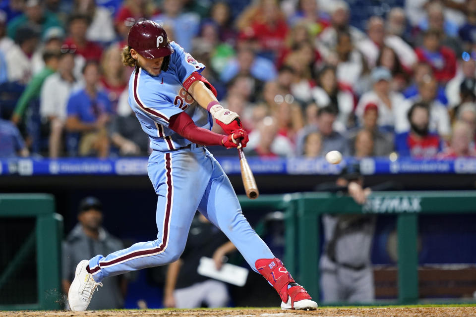 Philadelphia Phillies' Alec Bohm hits a two-run triple against Miami Marlins pitcher Sandy Alcantara during the fifth inning of a baseball game, Thursday, Sept. 8, 2022, in Philadelphia. (AP Photo/Matt Slocum)