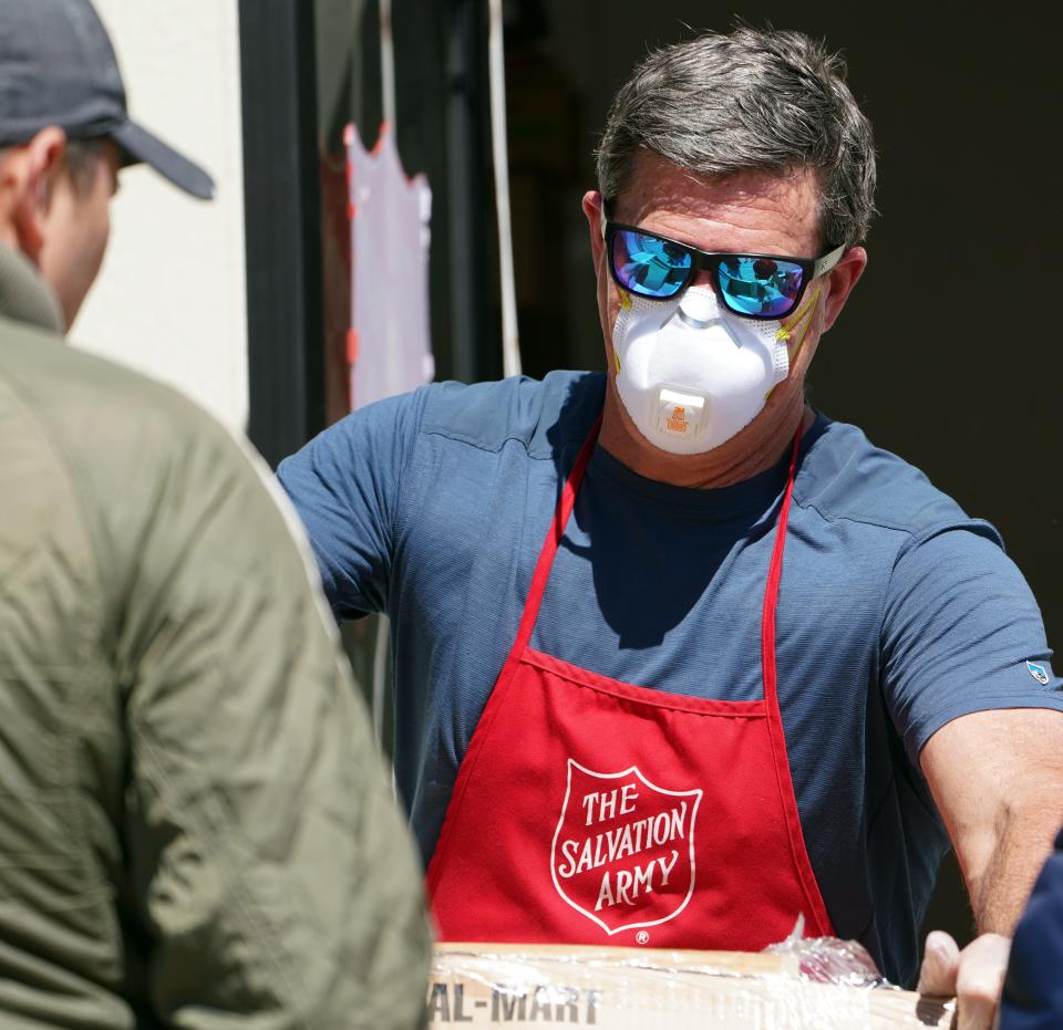 Volunteer Bob Boselli, 51, helps customers at the Avon, Colorado, Salvation Army food bank during the coronavirus outbreak on March 26, 2020.