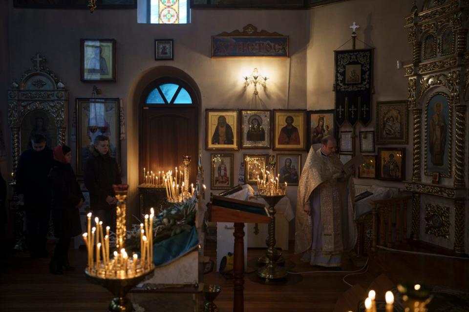 Ukrainians attend a Christmas mass at an Orthodox Church in Bobrytsia, near Kyiv, on Sunday (AP)