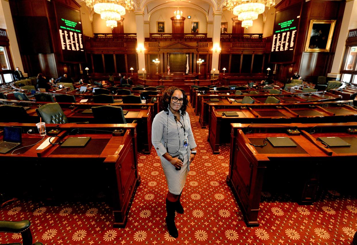 Chief Doorkeeper Nicole Hill, the first female doorkeeper for the Illinois State house, stands in front of the House chamber Wednesday, March 15, 2023, where she performs her job.    