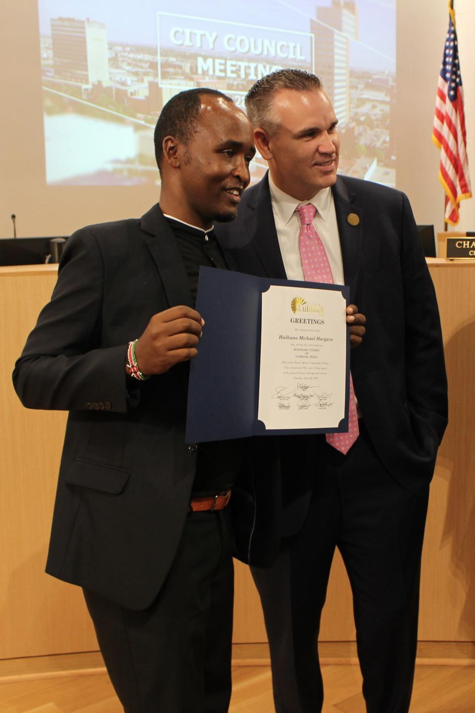 Halkano Michael Hargura of Kenya, a Mandela Washington Fellow, poses with Lubbock Mayor Tray Payne and a proclamation declaring Hargura an honorary Lubbock citizen Tuesday.