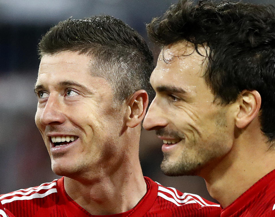 Bayern forward Robert Lewandowski, left, celebrates his side's second goal with Mats Hummers during the Champions League group E soccer match between FC Bayern Munich and AEK Athen in Munich, Germany, Wednesday, Nov. 7, 2018. (AP Photo/Matthias Schrader)