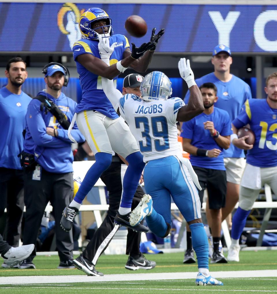 Rams receiver Van Jefferson jumps up for a pass against Lions defensive back Jerry Jacobs.