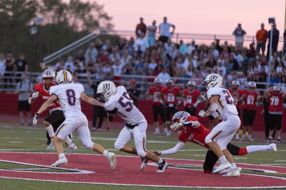 John Jay's Michael Aiello, center runs with the ball at a John Jay vs Somers Football Game at Somers High School.