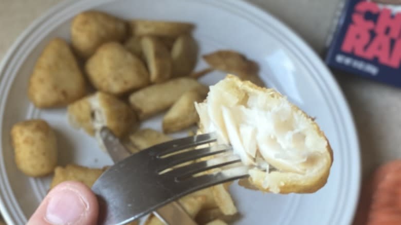 Piece of fish held over entire plate