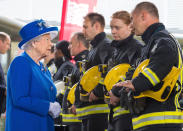 <p>Britain’s Queen Elizabeth II, left, meets firefighters during a visit to the Westway Sports Centre which is providing temporary shelter for those who have been made homeless by the fire at Grenfell Tower, in London, Friday June 16, 2017. (Photo: Dominic Lipinski/Pool Photo via AP) </p>