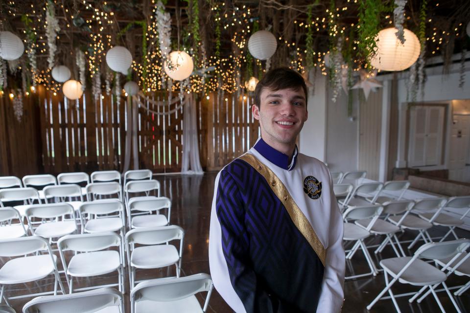 Stephen Stange, 17 of Lancaster, wears his Bloom-Carroll Marching Bulldogs band uniform stands inside of Cheers Chalet on Mar. 18, 2024, in Lancaster, Ohio. Stephen is the conductor for the Bloom-Carroll Marching Bulldogs and the Blue Stars Drum and Bugle Core. He is raising six thousand dollars to tour with the Blue Star Drum and Bugle Core this summer around d the United States.