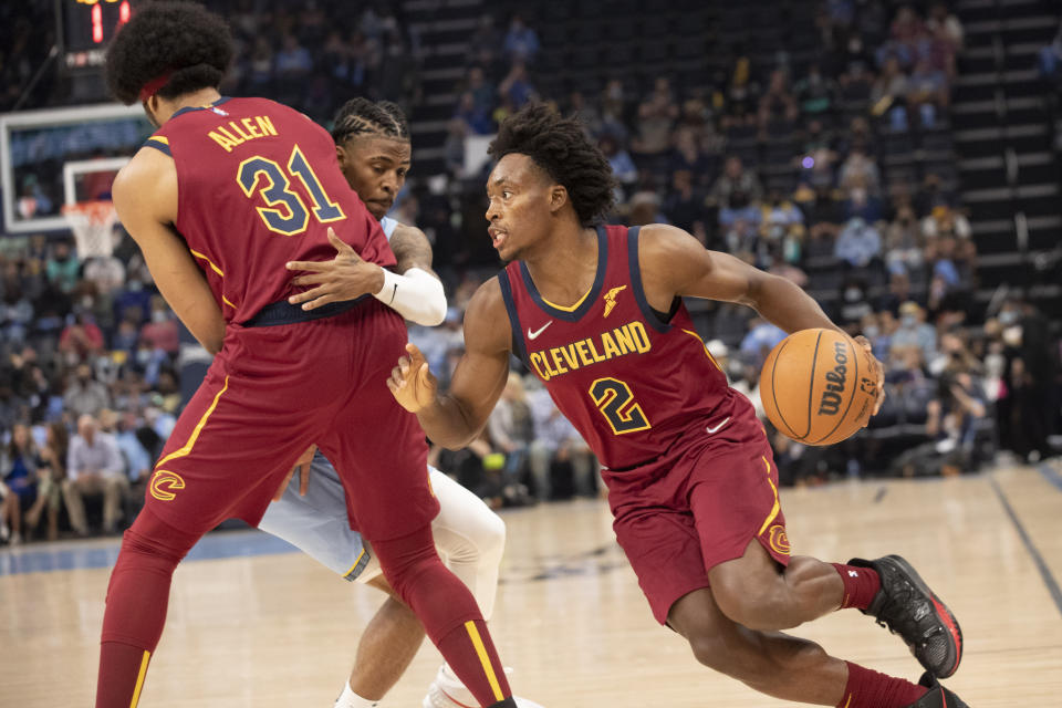 Cleveland Cavaliers' Collin Sexton (2) makes a move to the basket as Cleveland Cavaliers' Jarrett Allen (31) sets a screen on Memphis Grizzlies guard Ja Morant during the first half of an NBA basketball game Wednesday, Oct. 20, 2021, in Memphis, Tenn. (AP Photo/Nikki Boertman)