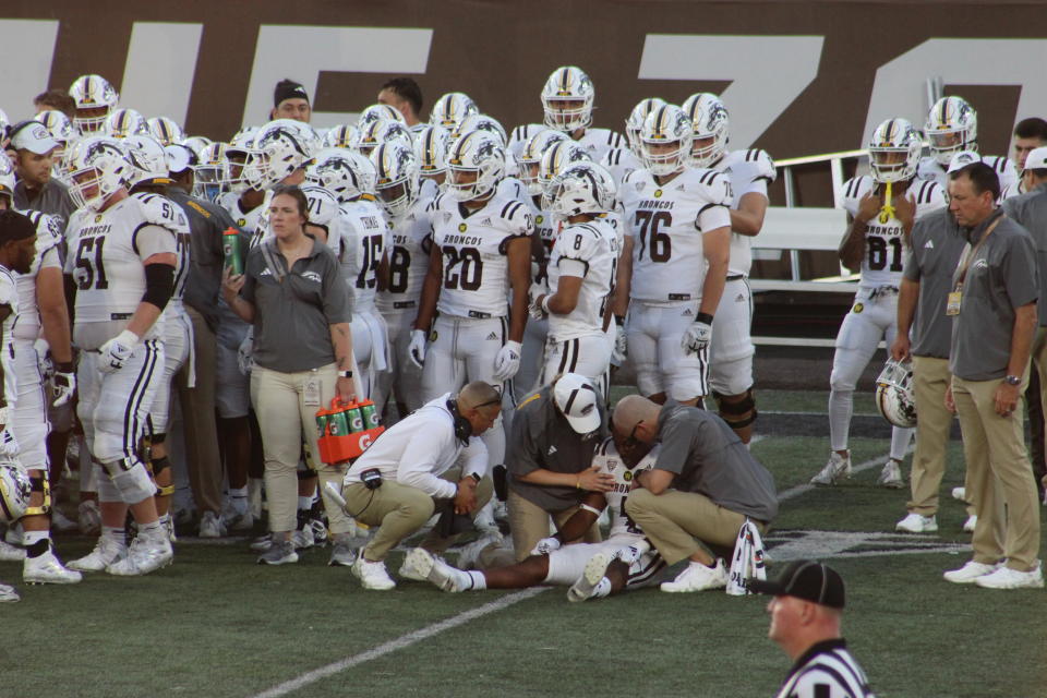 Coach Taylor tending to injured player who took a hard hit. (Photo/Levi Rickert)