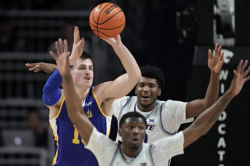 South Dakota State forward Luke Appel, left, passes under pressure from Kansas State guard Cam Carter, front, and forward Jerrell Colbert, back, during the second half of an NCAA college basketball game Monday, Nov. 13, 2023, in Manhattan, Kan. (AP Photo/Charlie Riedel)