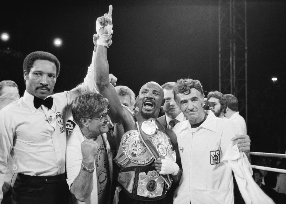 FILE - In this April 1985 file photo, middleweight champion Marvin Hagler celebrates his title with his manager, Pat Petronelli, and co-manager, Goody Petronelli, in Las Vegas. Hagler knocked out Thomas "Hitman" Hearns in the third round of the boxing bout. Hagler, the middleweight boxing great whose title reign and career ended with a split-decision loss to “Sugar” Ray Leonard in 1987, died Saturday, March 13, 2021. He was 66. (AP Photo)