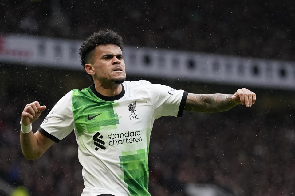 Liverpool's Luis Diaz, centre, celebrates after scoring the opening goal during the English Premier League soccer match between Manchester United and Liverpool at the Old Trafford stadium in Manchester, England, Sunday, April 7, 2024. (AP Photo/Dave Thompson)