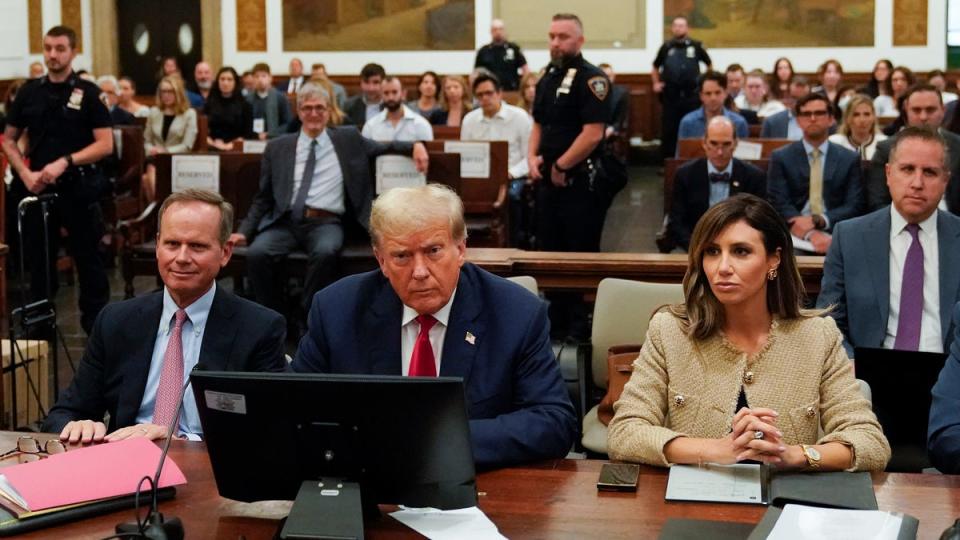 Former President Donald Trump, centre, sits in the courtroom with his legal team, including attorney Alina Habba (R) and Christopher Kise (L) (AP)