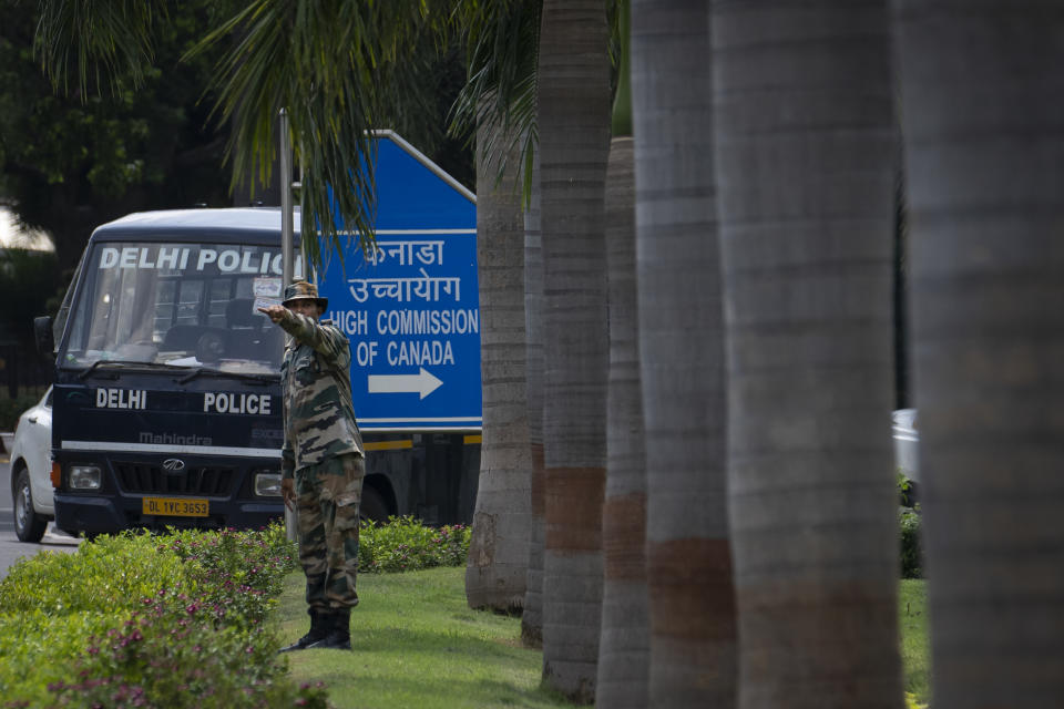 An Indian paramilitary soldier directs vehicles outside the Canadian High Commission in New Delhi, India, Tuesday, Sept. 19, 2023. Tensions between India and Canada are high after Prime Minister Justin Trudeau's government expelled a top Indian diplomat and accused India of having links to the assassination in Canada of Sikh leader Hardeep Singh Nijjar, a strong supporter of an independent Sikh homeland. (AP Photo/Altaf Qadri)