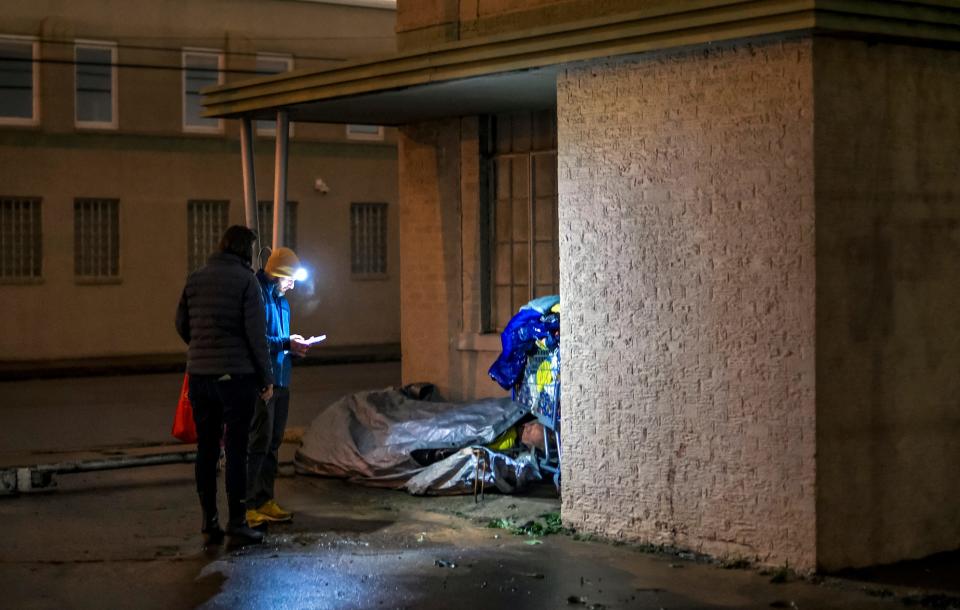 Jennifer Goodrich and Cale Powers interview a man who had been sleeping in an entryway early Thursday in northwest Oklahoma City during the Point-In-Time survey, coordinated by the Homeless Alliance, to count the homeless population.