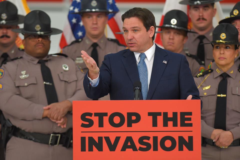 Florida Gov. Ron DeSantis addresses the audience backed by members of the Florida Highway Patrol, the Florida National Guard, and the Florida State Guard. DeSantis held a press conference in a hangar at Cecil Commerce Center on Jacksonville, Florida's westside Thursday, Feb. 1, 2024, to announce plans to deploy members of the Florida National Guard and the Florida State Guard to the borders of Texas and other areas to help slow down the tide of individuals entering the United States illegally. [Bob Self/Florida Times-Union]