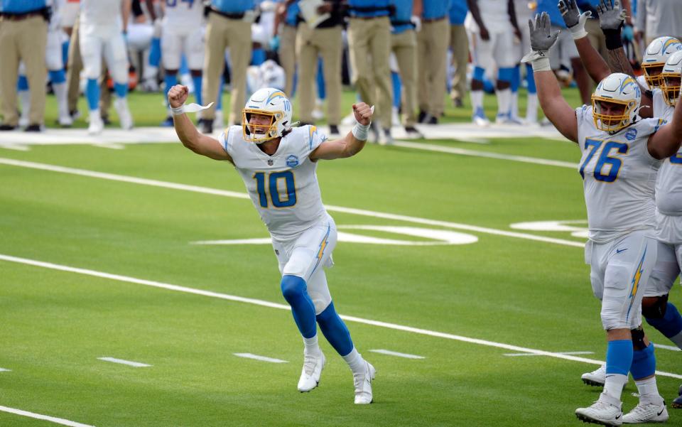 Los Angeles Chargers quarterback Justin Herbert celebrates after throwing his first career touchdown pass during the first half of an NFL football game against the Kansas City Chiefs Sunday, Sept. 20, 2020, in Inglewood, Calif. - AP