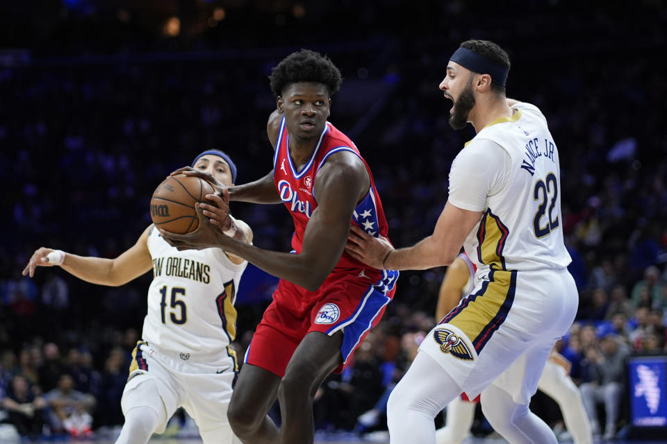 Philadelphia 76ers' Mo Bamba, center, tries to get past New Orleans Pelicans' Jose Alvarado, left, and Larry Nance Jr. during the first half of an NBA basketball game, Friday, March 8, 2024, in Philadelphia. (AP Photo/Matt Slocum)