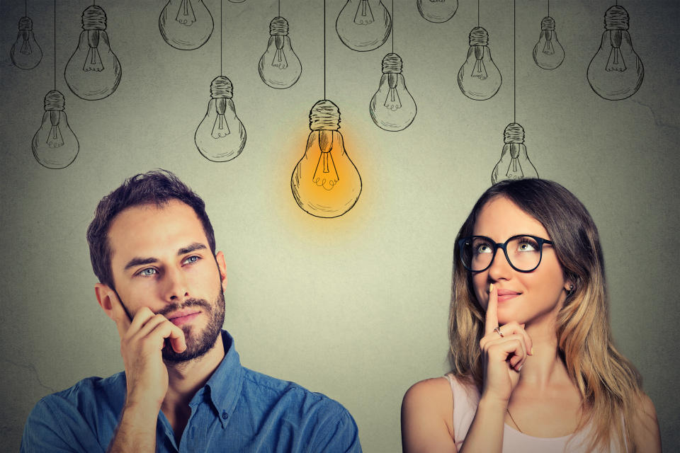 Man and woman with drawings of light bulbs behind them