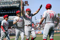 Philadelphia Phillies' Rhys Hoskins, second from right, celebrates after hitting a three-run home run that also scored Ronald Torreyes, left, and Luke Williams, second from left, during the seventh inning of a baseball game against the San Francisco Giants in San Francisco, Saturday, June 19, 2021. Phillies' J.T. Realmuto, right, looks on. (AP Photo/Jeff Chiu)