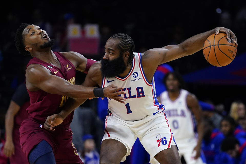 Philadelphia 76ers' James Harden, right, tries to get past Cleveland Cavaliers' Donovan Mitchell during the first half of a preseason NBA basketball game, Wednesday, Oct. 5, 2022, in Philadelphia. (AP Photo/Matt Slocum)