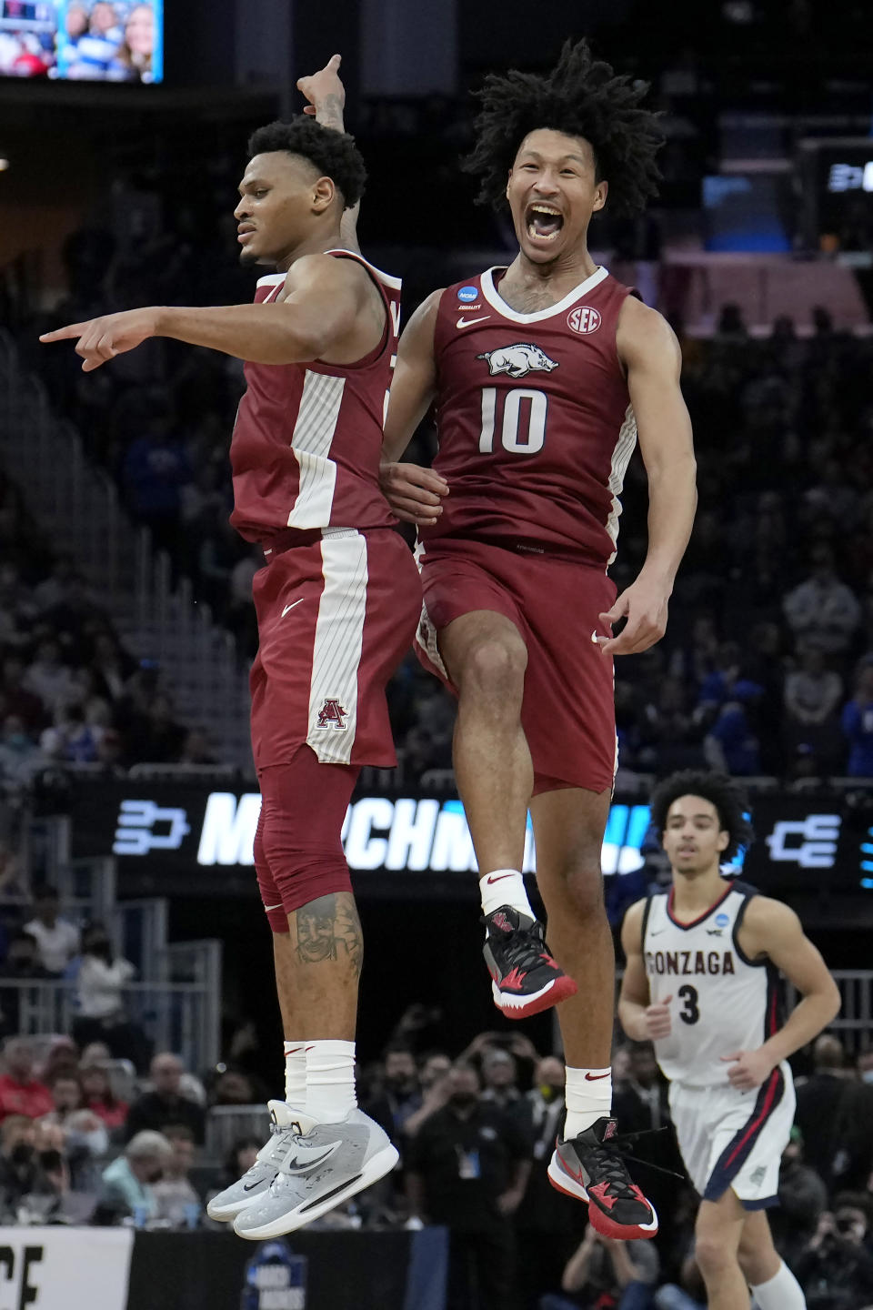 Arkansas guard Au'Diese Toney, left, celebrates with forward Jaylin Williams (10) during the second half of a college basketball game against Gonzaga in the Sweet 16 round of the NCAA tournament in San Francisco, Thursday, March 24, 2022. (AP Photo/Tony Avelar)