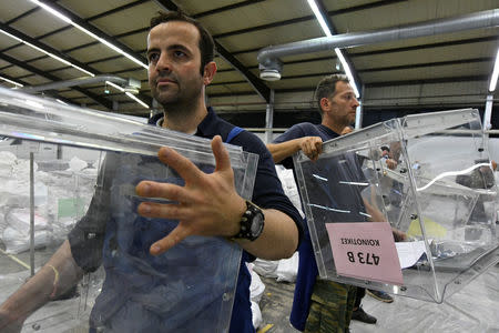 Municipal workers carry ballot boxes to be used in the upcoming European and local elections in Thessaloniki, Greece, May 24, 2019. REUTERS/Alexandros Avramidis