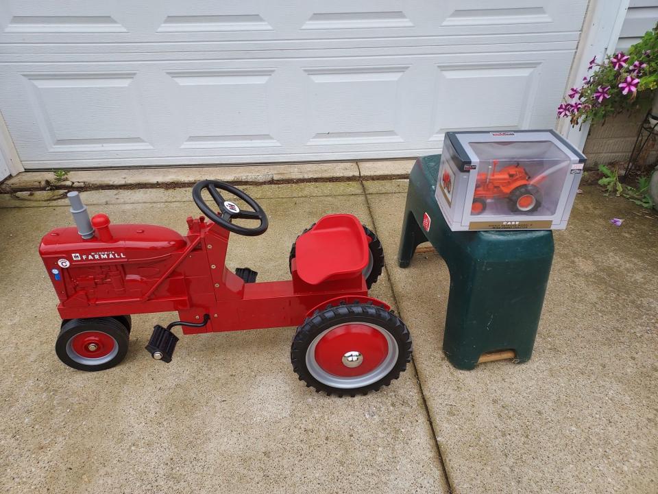 Pictured are the  IH Super C pedal tractor and a 1/16”-scale Case tractor that will be given away at the F.A.R.M. Tractor Show