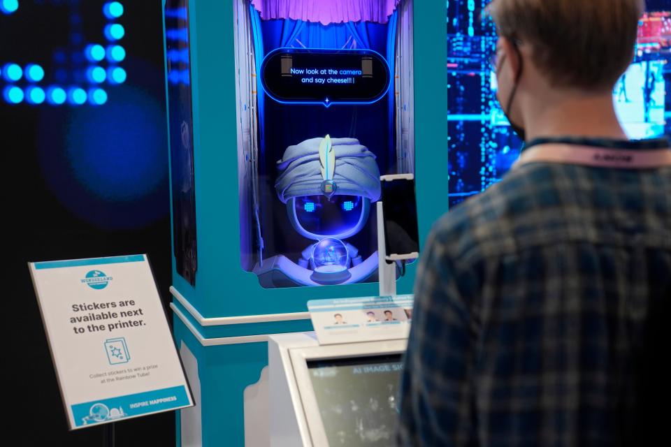 A person stands at an AI Fortune Teller at the SK booth during the CES tech show Wednesday, Jan. 10, 2024, in Las Vegas.