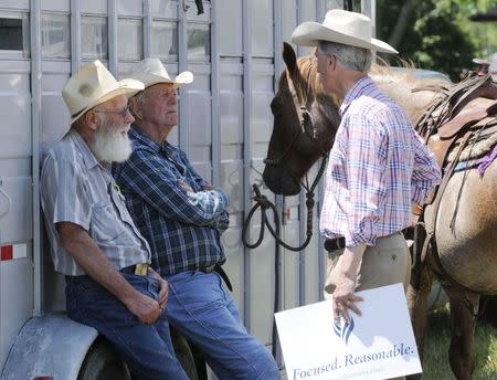 Democratic Senate candidate Dave Domina (R) greets Dale Buelt (L) and Bert Dozler prior to a parade in the town of Elgin, Nebraska June 22, 2014. REUTERS/Darin Epperly