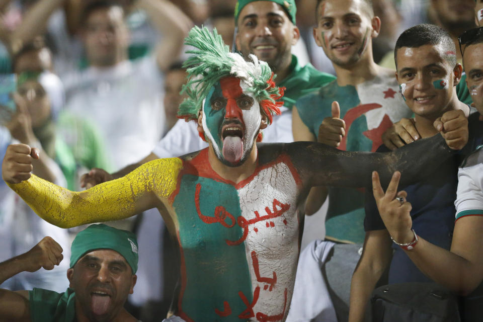 Algerian fans cheer before the African Cup of Nations final soccer match between Algeria and Senegal in Cairo International stadium in Cairo, Egypt, Friday, July 19, 2019. (AP Photo/Ariel Schalit)