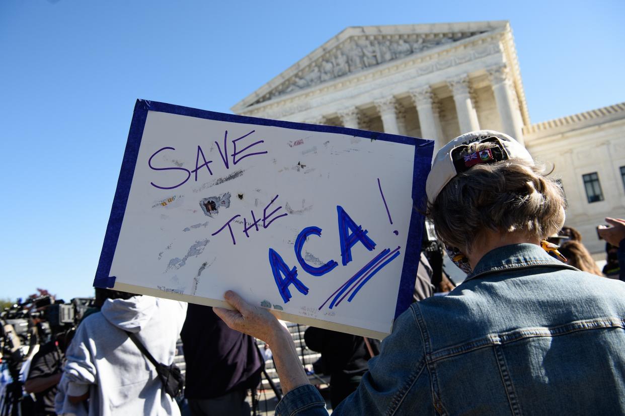 A demonstrator holds a sign in front of the US Supreme Court in Washington, DC, on November 10, 2020. (Photo by NICHOLAS KAMM / AFP) (Photo by NICHOLAS KAMM/AFP via Getty Images)