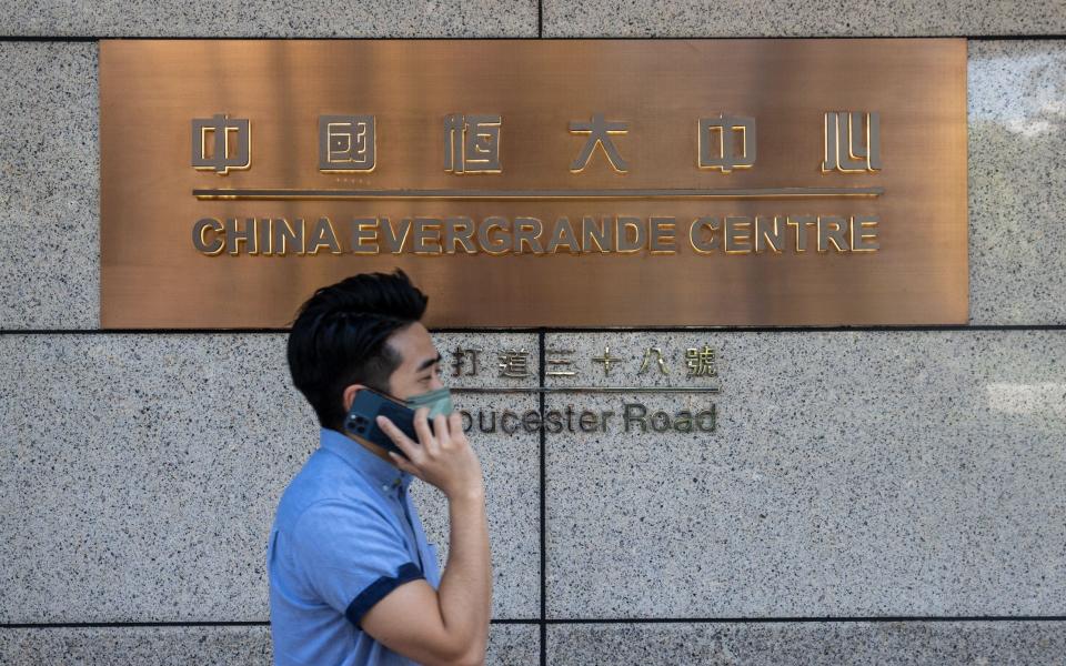 A man walks past the China Evergrande Centre in Hong Kong