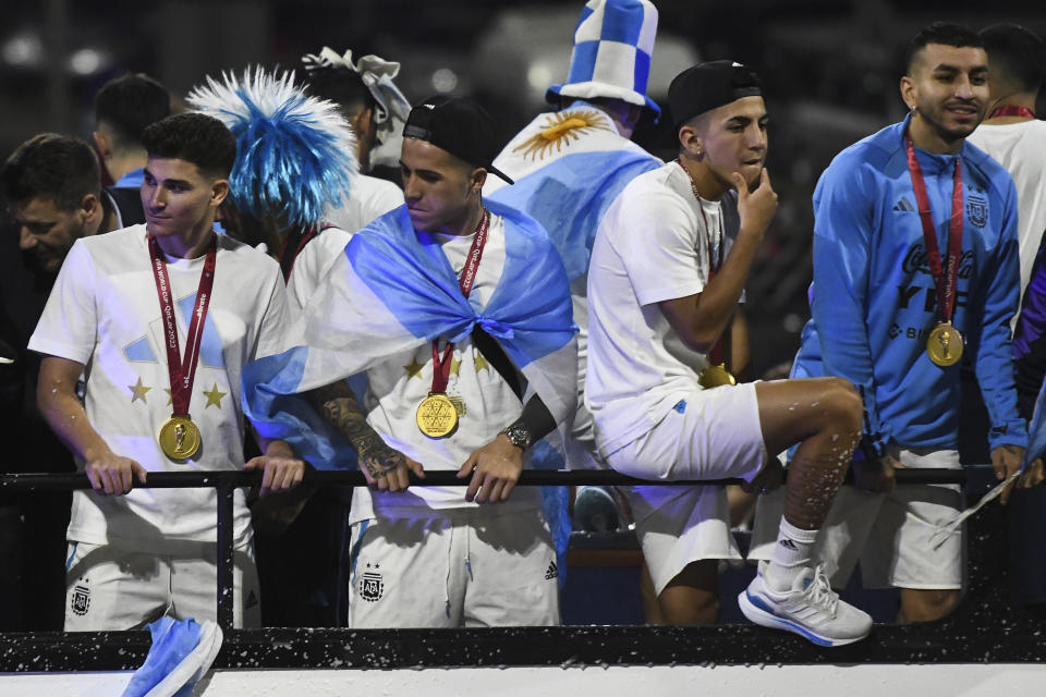 BUENOS AIRES, ARGENTINA - DECEMBER 20: Julian Alvarez, Enzo Fernandez and Thiago Almada of Argentina celebrate with the fans during the arrival of the Argentina men's national football team after winning the FIFA World Cup Qatar 2022 on December 20, 2022 in Buenos Aires, Argentina. (Photo by Rodrigo Valle/Getty Images)