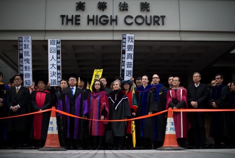 University lecturers and pro-democracy protestors gather at the high court on Friday for a march to the movement's main protest site in the Admiralty district of Hong Kong