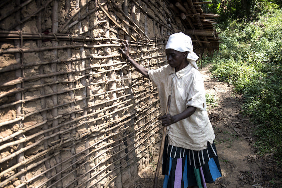 Mapuani, who lost her vision to river blindness, feels her way to the outhouse. (Photo: Neil Brandvold/DNDi)
