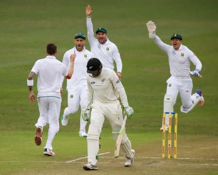 Members of South Africa celebrate the wicket of New Zealand's Martin Guptill during the second day of their first cricket test match in Durban, South Africa, August 20, 2016. REUTERS/Rogan Ward