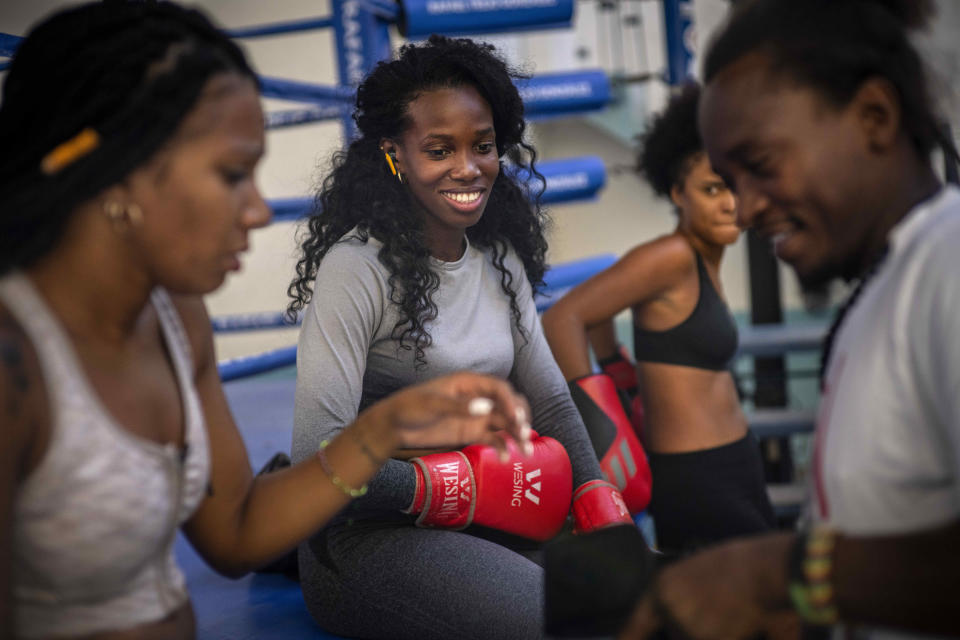 Boxer Legnis Cala, center, talks with fellow female boxers during a training session in Havana, Cuba, Monday, Dec. 5, 2022. Cuban officials announced on Monday that women boxers would be able to compete for the first time ever. (AP Photo/Ramon Espinosa)