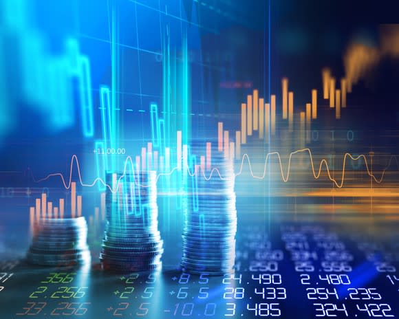 Rising stock graph with piles of coins and columns of numbers.