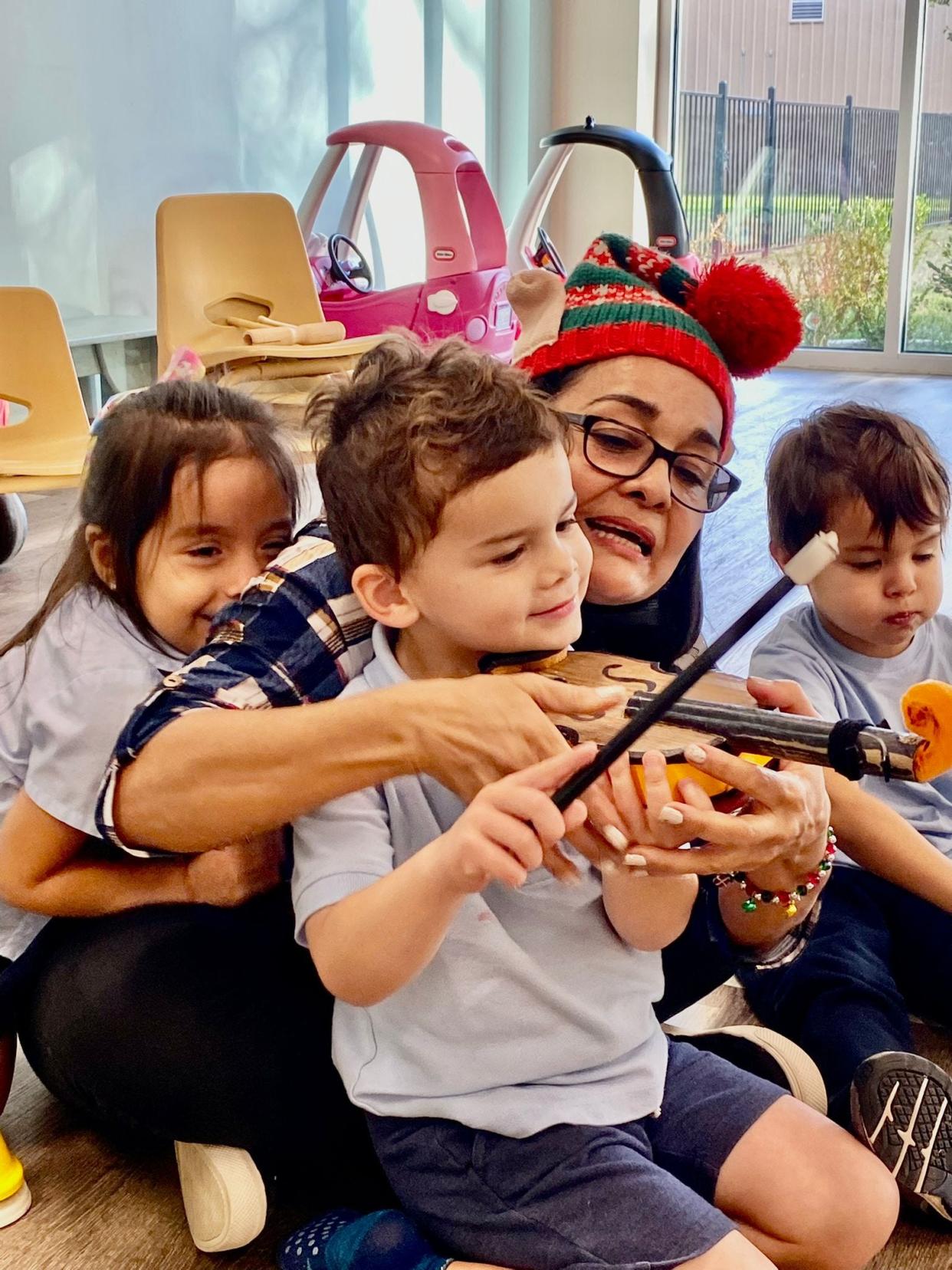 An instructor teaching a child how to use an instrument.