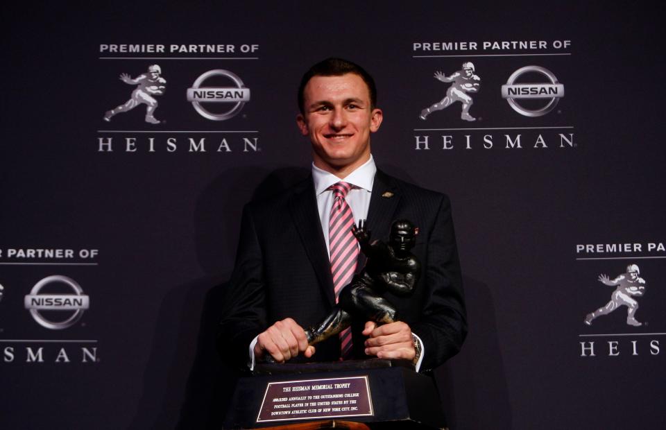 Dec 8, 2012; New York, NY, USA; Texas A&M Aggies quarterback Johnny Manziel poses for a photo with the Heisman Trophy during a press conference before the announcement of the 2012 Heisman Trophy winner at the Marriott Marquis in downtown New York City.  Mandatory Credit: Jerry Lai-USA TODAY Sports