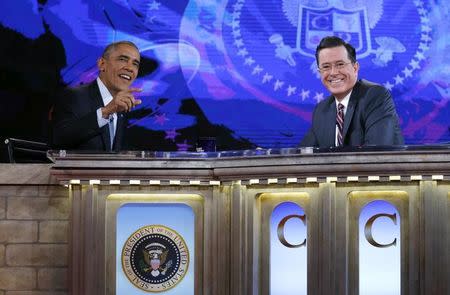 U.S. President Barack Obama (L) appears on The Colbert Report with Stephen Colbert at the Lisner Auditorium at George Washington University in Washington December 8, 2014. REUTERS/Kevin Lamarque