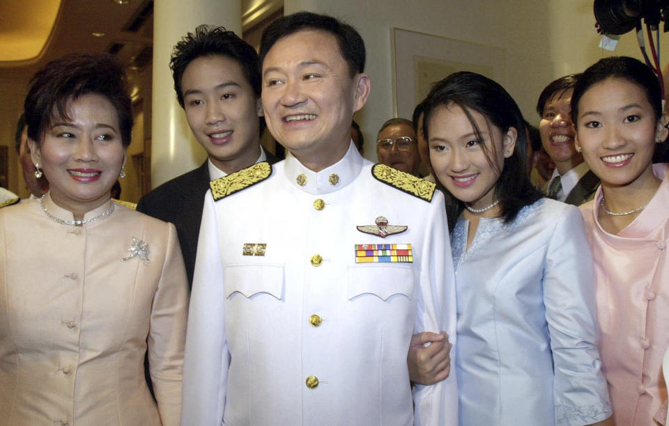 FILE - Newly-elected Thai Prime Minister Thaksin Shinawatra, center, is photographed with his wife Pojamarn, left, son Parntongtae, second left, and daughters Paetongtarn, right, and Pintongta, second right, after receiving the royal command appointed him as Thailand's 23rd prime minister at a ceremony at his residence in Bangkok Friday, Feb. 9, 2001. Thaksin Shinawatra, a controversial former Prime Minister of Thailand, made his dramatic return to Thailand last year after nearly a decade of self-imposed exile. Although he was detained in a hospital and never appeared in the public eye for six months after his arrival, his presence in the country alone brings a turmoil into Thai politics like no other politician could ever achieve. (AP Photo/Sakchai Lalit,File)