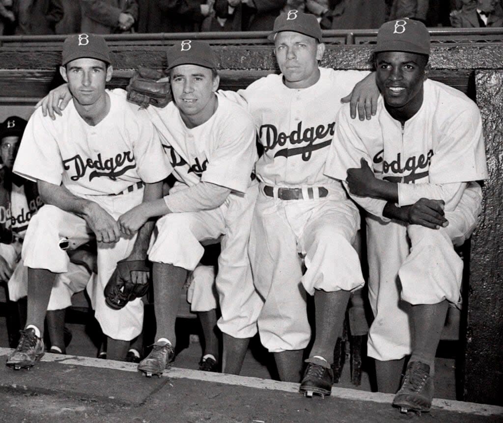 FILE – From left, Brooklyn Dodgers third baseman John Jorgensen, shortstop Pee Wee Reese, second baseman Ed Stanky, and first baseman Jackie Robinson pose before a baseball game against the Boston Braves at Ebbets Field in Brooklyn, N.Y., April 15, 1947. Already at the forefront on the 75th anniversary of breaking baseball’s color barrier, Jackie Robinson’s life, legacy and impact is honored as part of the 2022 baseball All-Star Game in Los Angeles. (AP Photo/Harry Harris, File)