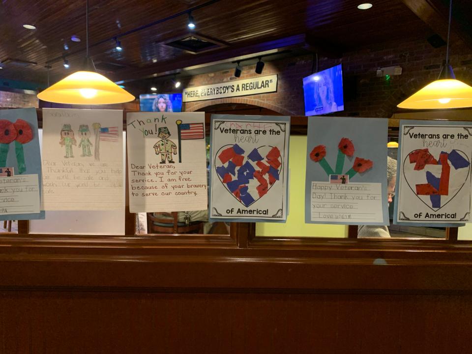 Elementary school children honor veterans with their art at a local restaurant.