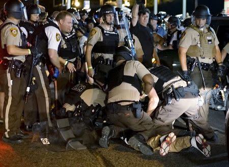Police detain a protester in Ferguson, Missouri, August 10, 2015. REUTERS/Rick Wilking