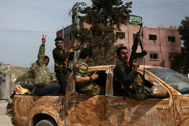 Turkish-backed Syrian rebels gather in the city of Afrin in northern Syria on March 18, 2018