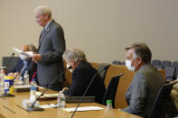 Bill Smith, right, interim chief executive officer and president of PG&E Corp., lowers his head as Butte County District Attorney Michael Ramsey, left, makes his closing statement during the criminal sentencing hearing in the trial of Pacific Gas & Electric Corp in Chico, Calif., Thursday, June 18, 2020. Pacific Gas & Electric on Thursday was fined $4 million for the deaths of 84 people killed in a nightmarish Northern California wildfire ignited by the its long-neglected electrical grid. The sentencing comes as the nation's largest utility prepares to end a 17-month bankruptcy proceeding triggered by the catastrophe. (AP Photo/Rich Pedroncelli, Pool)