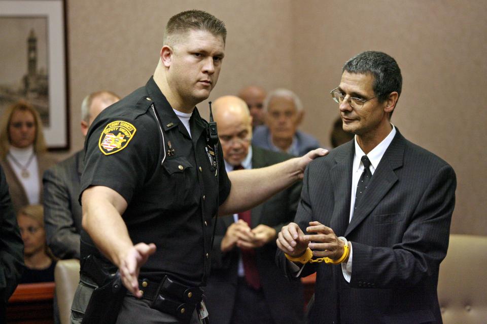 Dr. Mark Blankenburg is taken into custody after being found guilty of 16 sex-related charges involving former patients, Friday Oct. 16, 2009, in front of Butler County Common Pleas Judge Keith Spaeth in Hamilton, Ohio. His twin brother Dr. R. Scott Blankenburg, also a pediatrician, will be tried on 22 similar felony charges April 2010 in Hamilton, Ohio. (AP Photo/Hamilton Journal News, Nick Daggy)